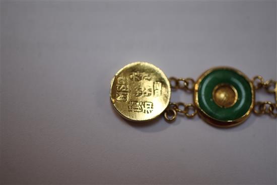 A Chinese gold and jadeite disc link bracelet, 6.75in.